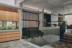 Modern minimalist interior design featuring exposed concrete flooring and minimalist furniture.