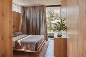 A modern bedroom featuring wooden furniture and a cozy atmosphere.
