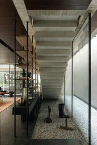 A modern interior with concrete stairs and glass railings.
