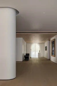 A modern interior with white marble walls and floor, featuring minimalist decor and a sleek, contemporary design.