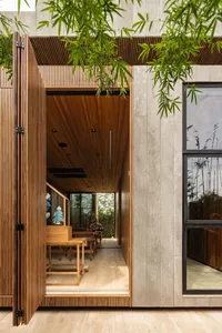 A modern residential interior featuring wood accents and concrete elements.
