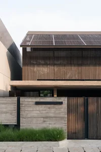 Modern building exterior featuring wood and concrete materials.