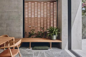 Modern interior design with wooden furniture and concrete elements.