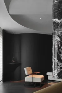 Modern living room featuring sleek marble columns and plush upholstered furniture.