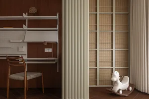 A minimalist home office with wooden furniture and shelves.