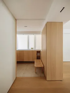 Modern residential kitchen interior with wooden cabinetry and countertop.