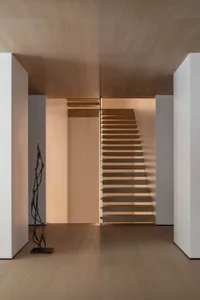 Modern wood staircase with a minimalist design, featuring a sleek, straight line and no railing.