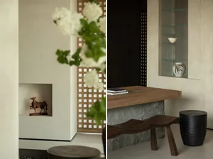 A modern industrial living room featuring a wooden and cement hanging shelf with a metal frame, complemented by white flowers