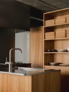 Modern kitchen featuring wooden cabinets and stainless steel hardware.