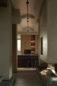 A modern residential kitchen featuring wooden finishes and minimalist design elements.