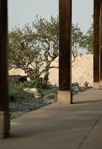 Stone pathway with a garden alongside, leading to an outdoor space.