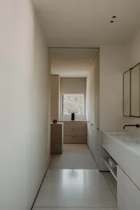 A modern bathroom featuring marble finishes and minimalist design elements.
