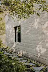 A minimalist building with a modern concrete exterior.