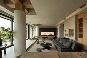 Modern, minimalist interior design featuring concrete walls and floors with sleek, contemporary furniture.