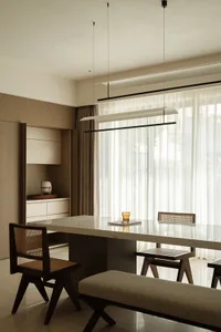 Modern residential dining room featuring a sleek marble tabletop with minimalist design.