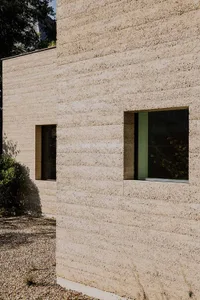 Modern building exterior with concrete walls and small windows