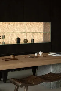 A modern living room featuring wooden furniture and shelves with decorative items.