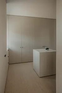 A minimalist closet with modern design and soft, neutral materials.