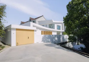 Modern residential building with a white concrete exterior.