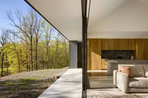A modern residential interior with concrete flooring and wooden accents.