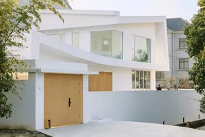 Modern residential house with white exterior and large glass windows