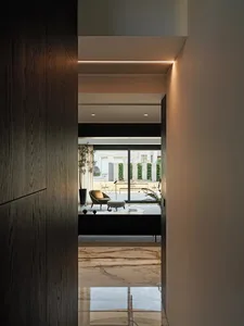 Modern living room with marble flooring and minimalist decor.