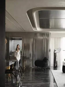 A modern residential kitchen featuring metallic finishes and sleek design elements.