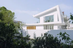 White modern house with concrete exterior.