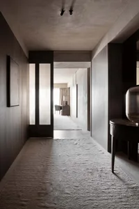 A minimalist hallway with light-colored wood paneling and a soft, neutral color palette.