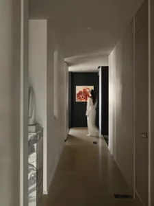 A modern interior corridor with white mineral walls, featuring a minimalist design.