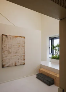 Modern interior space with wooden benches, concrete steps, and abstract art