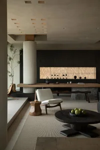 A modern living room featuring minimalist design with wooden furniture and concrete accents.