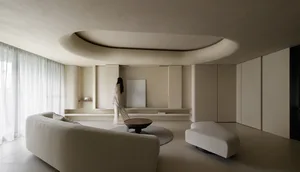 A modern living room with neutral-colored furniture and minimalist decor.