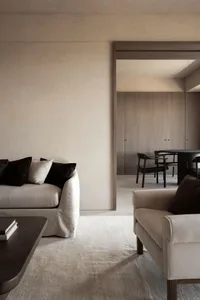 A neutral-toned living room with minimalist furniture and earthy color palette.