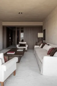 A minimalist living room with neutral-toned furniture and minimalist decor.