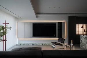 A minimalist living room featuring white marble floors and black steel furniture.
