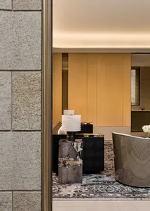 A minimalist office space featuring a concrete desk and modern design elements.