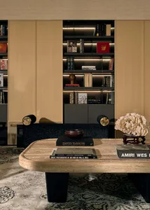 A modern interior living room with a concrete table, wooden shelves, and leather seating.