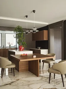 Contemporary kitchen with marble countertops, wooden cabinets, and glass pendant lights.