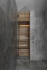 Modern marble bathroom with industrial lighting and minimalist design.