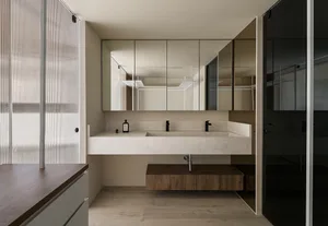 A minimalist bathroom featuring modern materials, with a concrete countertop and wooden cabinet.