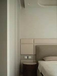 Modern minimalist bedroom showcasing wall paneling and floor plan details.
