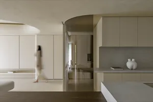 A modern, minimalist kitchen features concrete countertops and wooden cabinets, with a sleek, clean design.