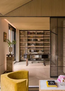 An elegant office library with glass and marble elements, featuring a contemporary design.