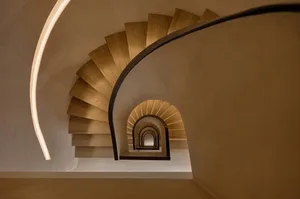 A modern, spiral staircase constructed of wood.