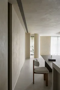 A minimalist interior design space featuring neutral-toned materials and modern, clean lines.