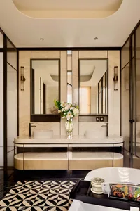 Modern bathroom featuring a luxurious marble vanity and double sinks.