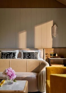 Modern bedroom featuring plush fabric upholstery and sleek, contemporary furnishings.