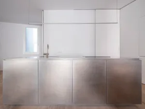 A modern kitchen with sleek, stainless steel cabinets and a minimalist design.