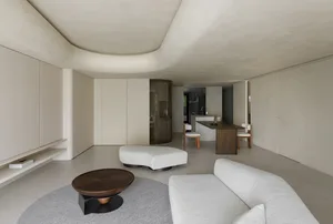 A modern minimalist living room with neutral-tones and clean lines.